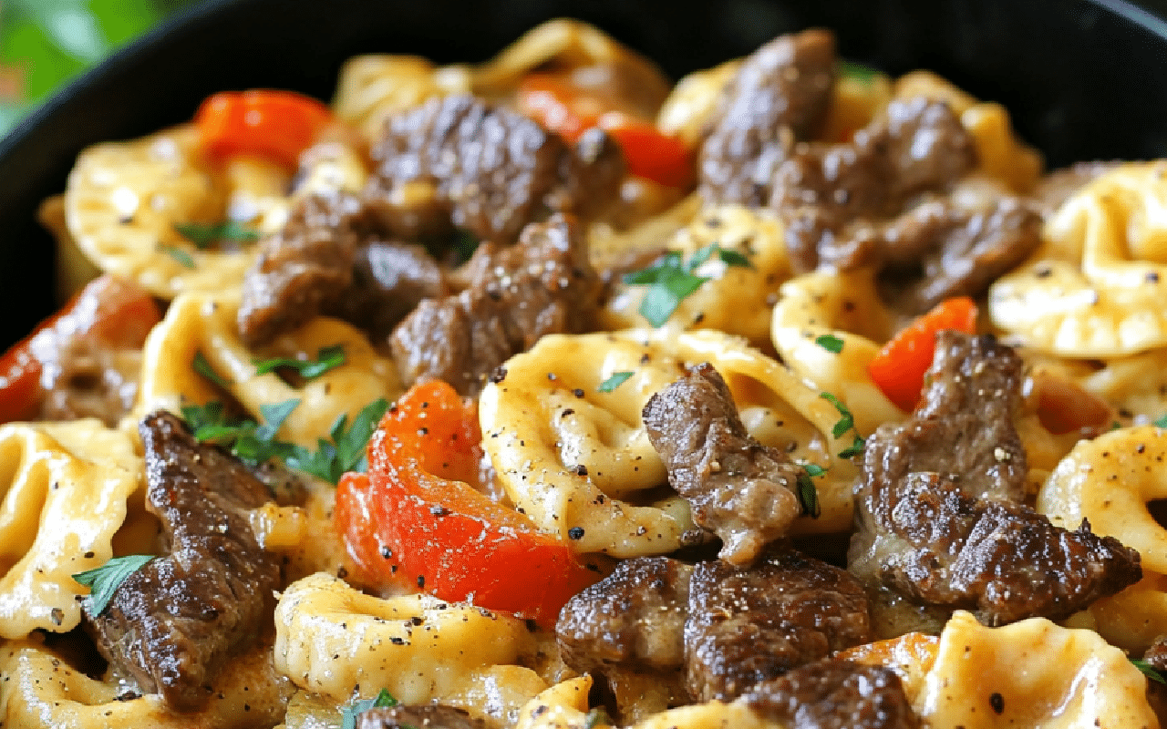 cheesy cheesesteak tortellini combines steak, peppers, and pasta in one hearty skillet dish